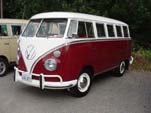 Volkswagen 13-window deluxe bus is painted titian red on the lower part