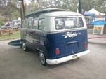 Sea blue vintage VW 21-window samba bus with a large Hobie Surfboards decal on back