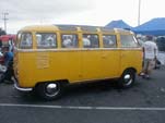 Yellow Volkswagen 23-window deluxe samba bus with pressed bumpers