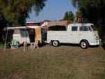 Great Looking Rig is a VW Double Cab Pickup Towing a Vintage Eriba Puck Travel Trailer Setup For Camping